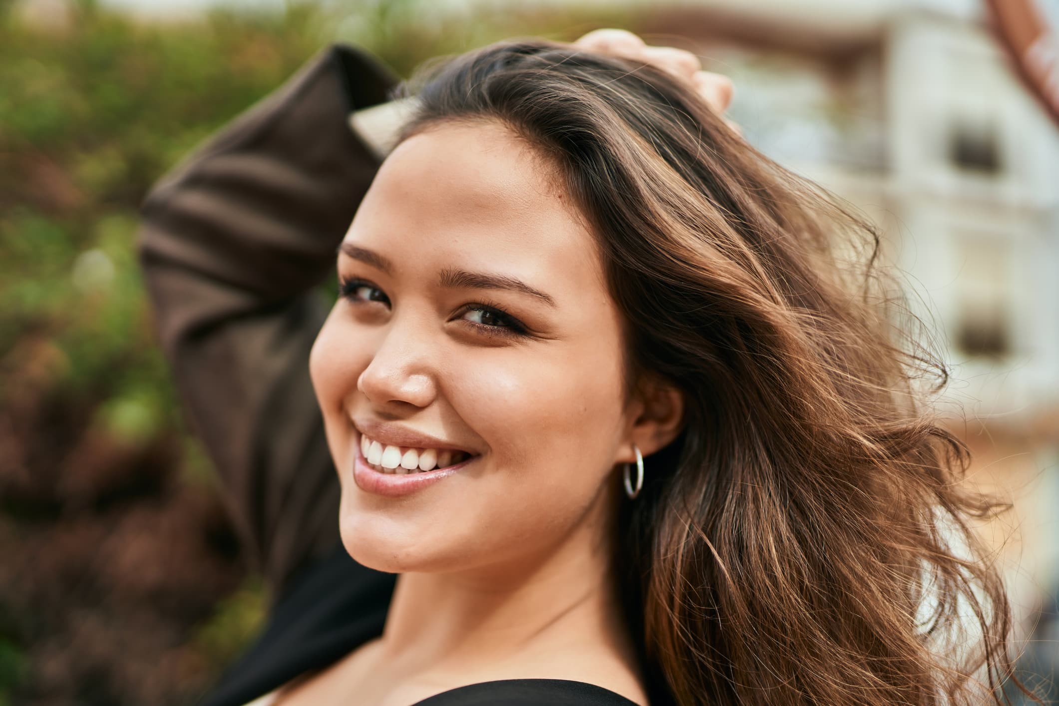 young woman smiling in park 